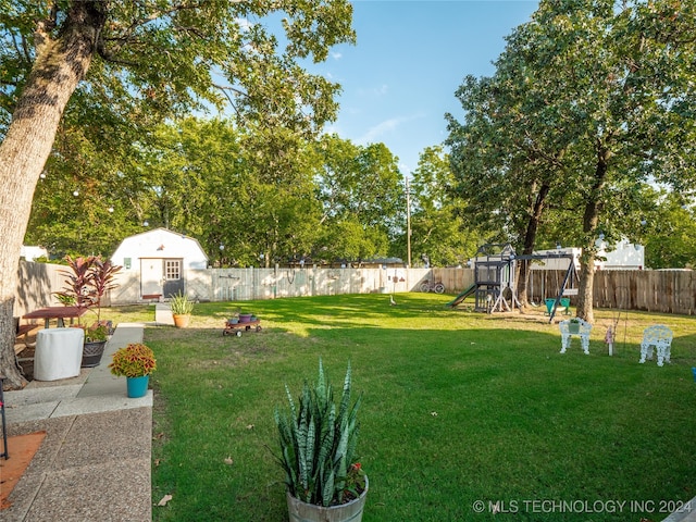 view of yard featuring a playground and a storage unit