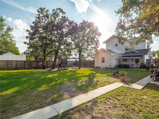 view of yard featuring a playground and a patio