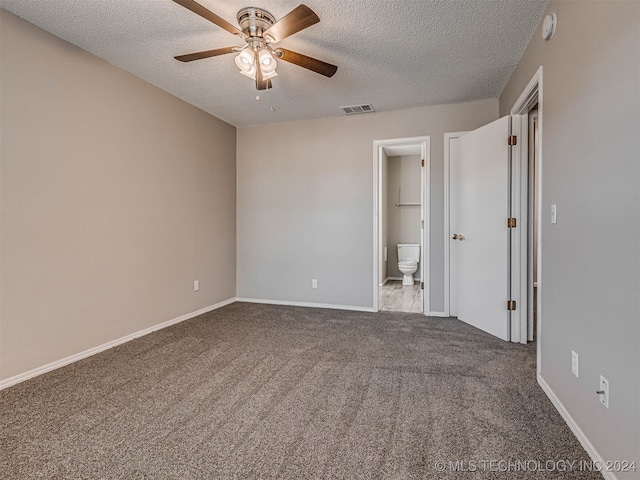 unfurnished bedroom featuring ensuite bath, ceiling fan, carpet, and a textured ceiling