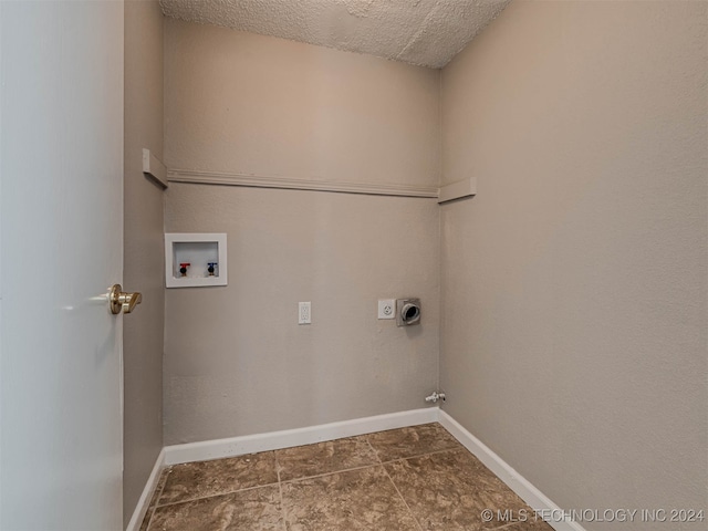 clothes washing area featuring hookup for a washing machine, a textured ceiling, hookup for a gas dryer, and electric dryer hookup