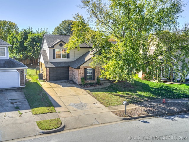 view of front of property featuring a front lawn, a garage, and central AC unit