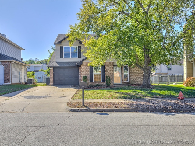 view of front of house featuring a garage and a front lawn