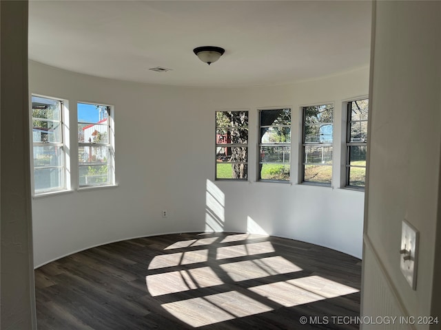 spare room with dark hardwood / wood-style floors