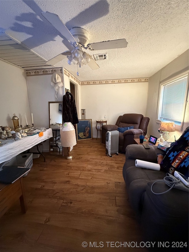 interior space featuring wood-type flooring, a textured ceiling, and ceiling fan