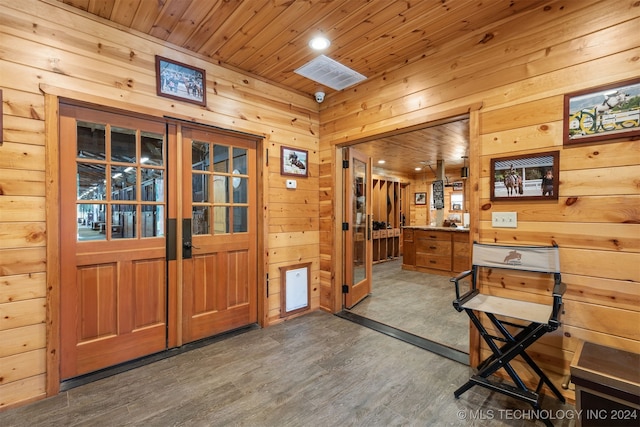 entryway with dark hardwood / wood-style floors, wooden ceiling, and wood walls