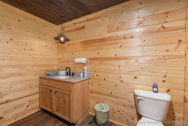 bathroom with hardwood / wood-style floors, vanity, wood walls, toilet, and wood ceiling