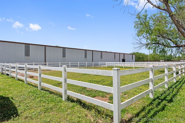 view of yard featuring a rural view and an outdoor structure