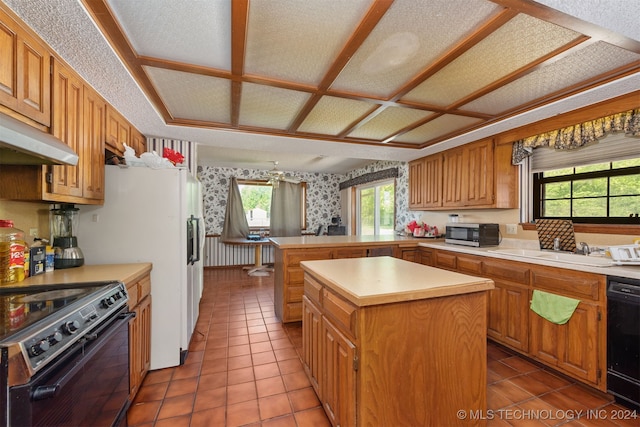 kitchen featuring black appliances, sink, tile patterned flooring, a textured ceiling, and a kitchen island