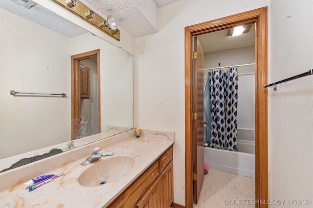 bathroom featuring vanity, shower / bath combo, a textured ceiling, and tile patterned floors