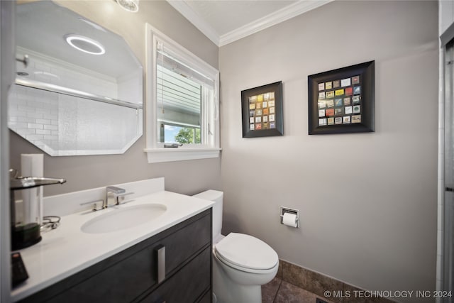 bathroom featuring vanity, a shower with door, tile patterned flooring, toilet, and ornamental molding