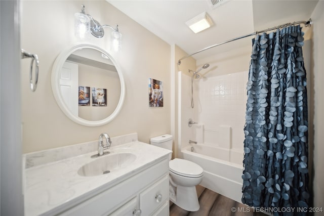 full bathroom with toilet, shower / bath combo with shower curtain, vanity, and hardwood / wood-style flooring