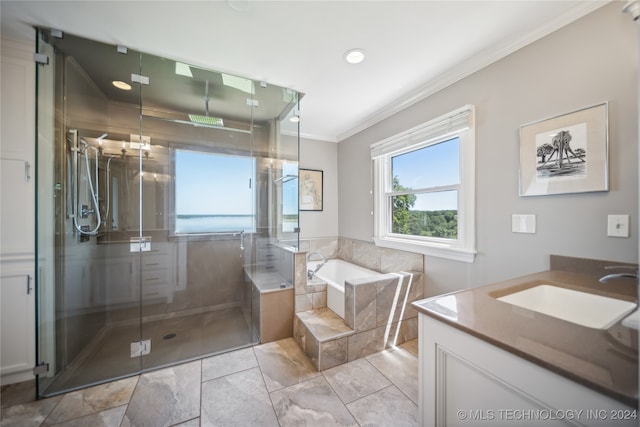 bathroom featuring plus walk in shower, vanity, and ornamental molding