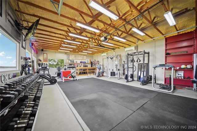 exercise room featuring a workshop area and a wall mounted air conditioner