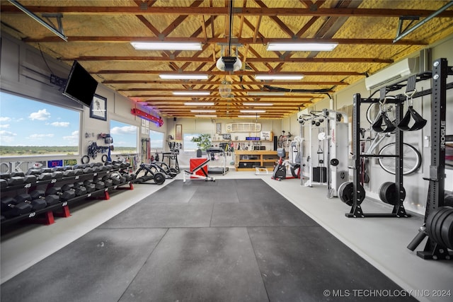 exercise room featuring a workshop area and a wall mounted AC