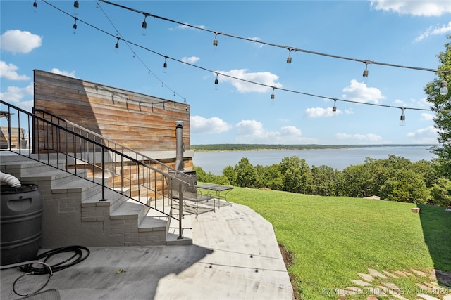 view of yard featuring a water view and a patio area