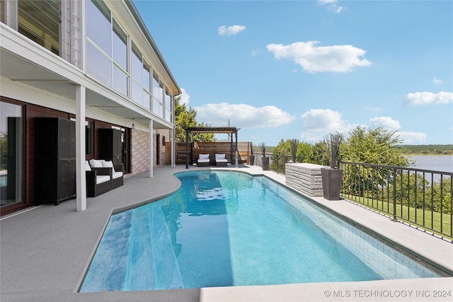 view of pool with a water view and a patio