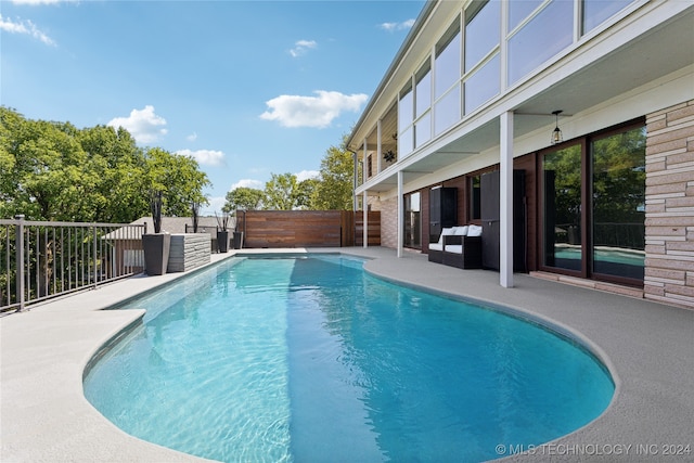 view of swimming pool with a patio area