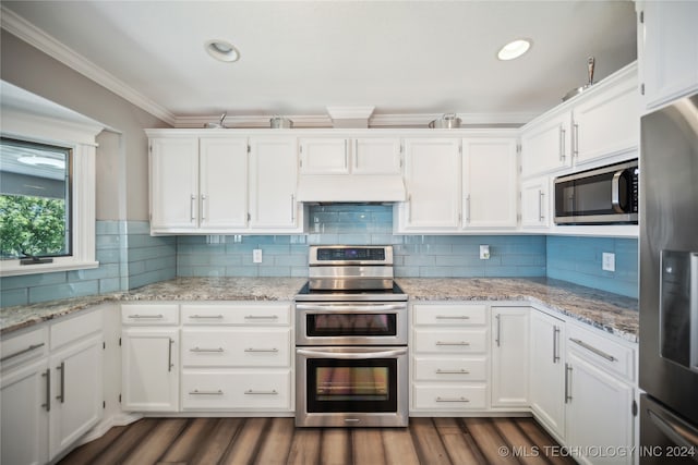 kitchen featuring white cabinetry, dark hardwood / wood-style floors, crown molding, decorative backsplash, and appliances with stainless steel finishes