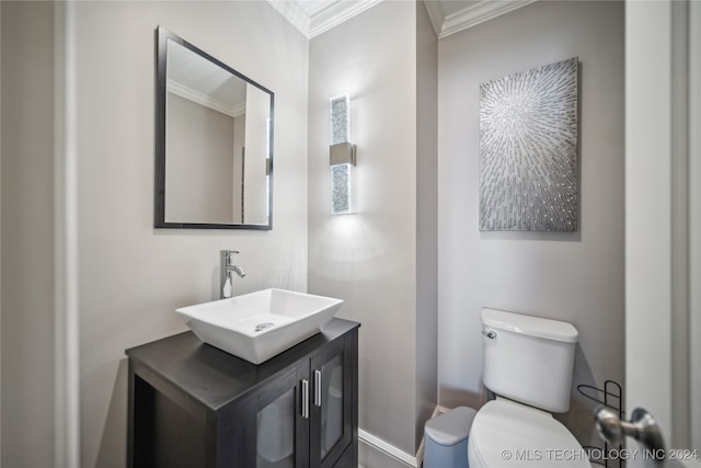 bathroom with crown molding, vanity, and toilet