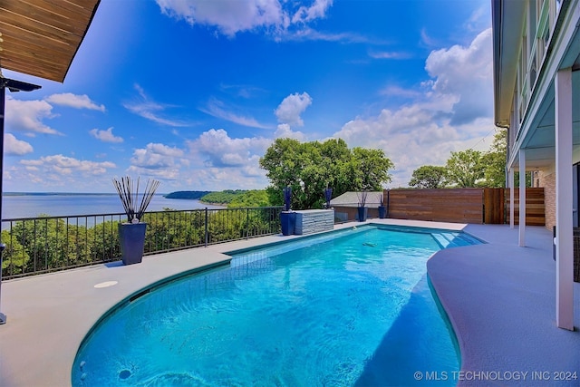 view of swimming pool with a water view and a patio