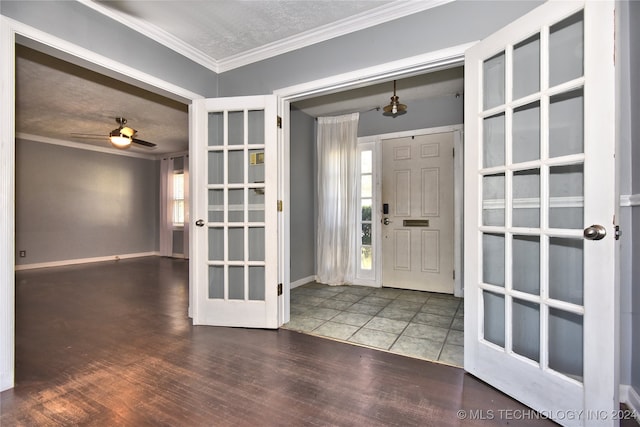 entrance foyer featuring dark hardwood / wood-style floors, ceiling fan, plenty of natural light, and ornamental molding