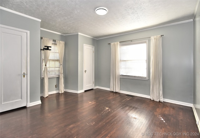 unfurnished bedroom with dark wood-type flooring, a textured ceiling, and ornamental molding