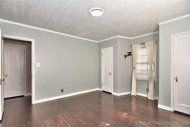 unfurnished bedroom featuring ornamental molding, a textured ceiling, and dark wood-type flooring