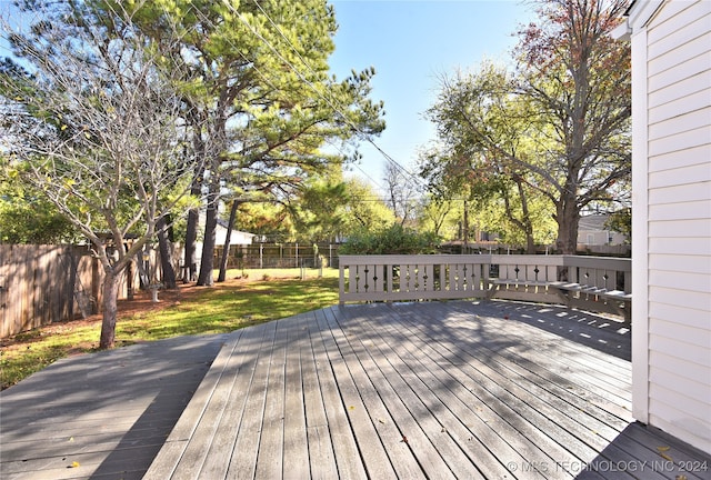 wooden deck featuring a yard