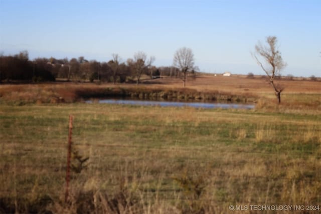 view of yard with a rural view and a water view