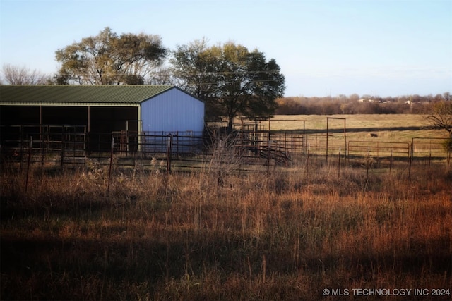 view of yard with a rural view and an outdoor structure