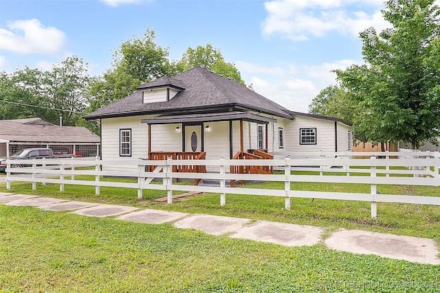 bungalow featuring a porch and a front lawn