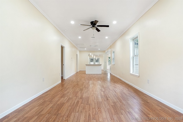 unfurnished living room featuring ceiling fan, crown molding, and light hardwood / wood-style floors