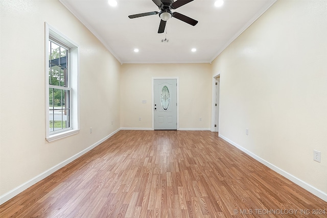 foyer entrance featuring ceiling fan, a healthy amount of sunlight, light wood-type flooring, and ornamental molding