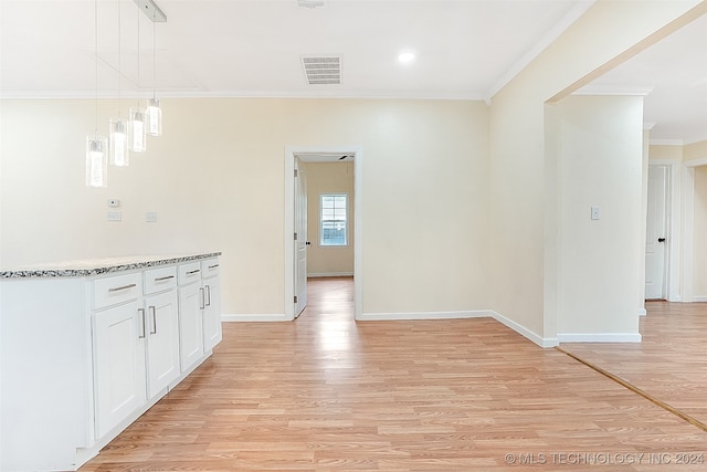 hall with crown molding and light hardwood / wood-style flooring