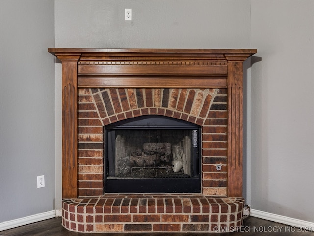 interior details featuring a fireplace and wood-type flooring