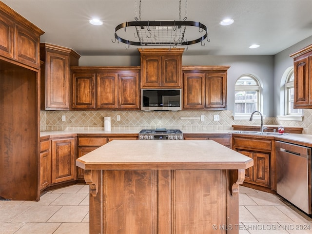 kitchen with tasteful backsplash, a center island, and appliances with stainless steel finishes