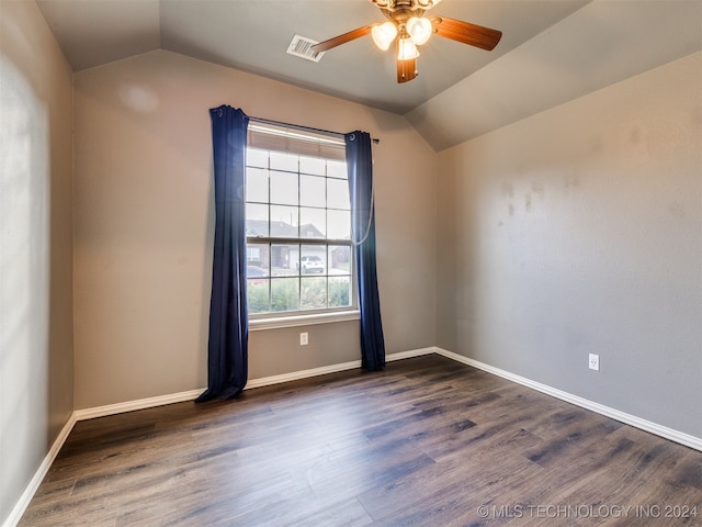 spare room with vaulted ceiling, ceiling fan, and dark wood-type flooring