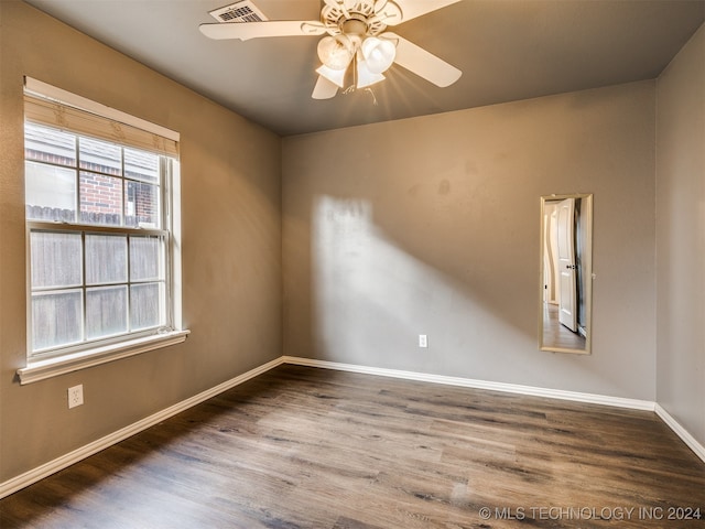 empty room with hardwood / wood-style floors and ceiling fan