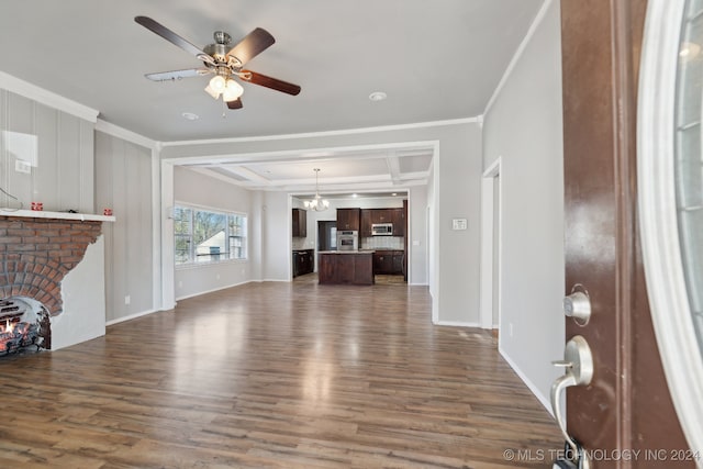 living room with dark wood-type flooring, ceiling fan, and ornamental molding