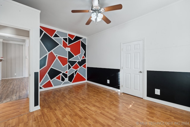 unfurnished room featuring ornamental molding, hardwood / wood-style floors, and ceiling fan