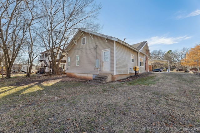 view of property exterior featuring a yard and a carport