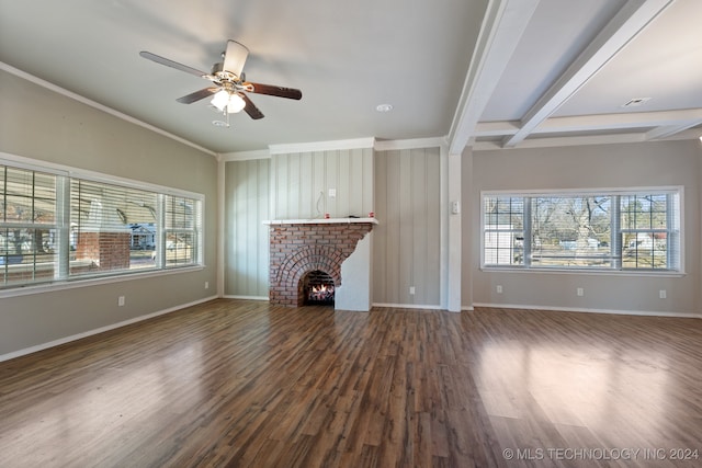 unfurnished living room featuring a brick fireplace, dark wood-type flooring, beamed ceiling, and ceiling fan