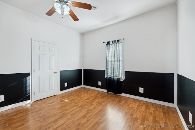 spare room featuring hardwood / wood-style flooring, crown molding, and ceiling fan