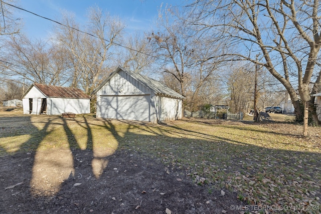 view of yard with a garage and an outdoor structure