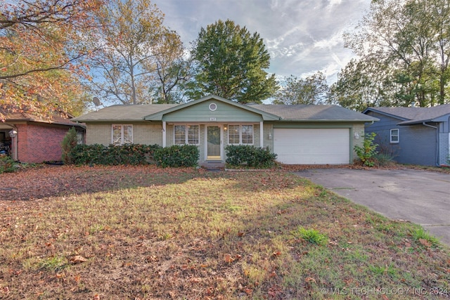 single story home featuring a front yard and a garage