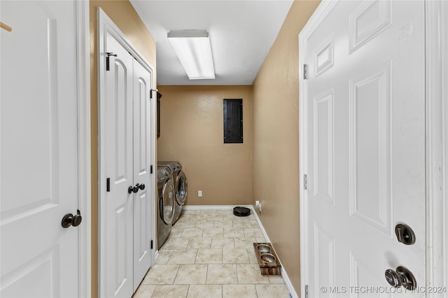 laundry room with washer and dryer, light tile patterned flooring, and electric panel