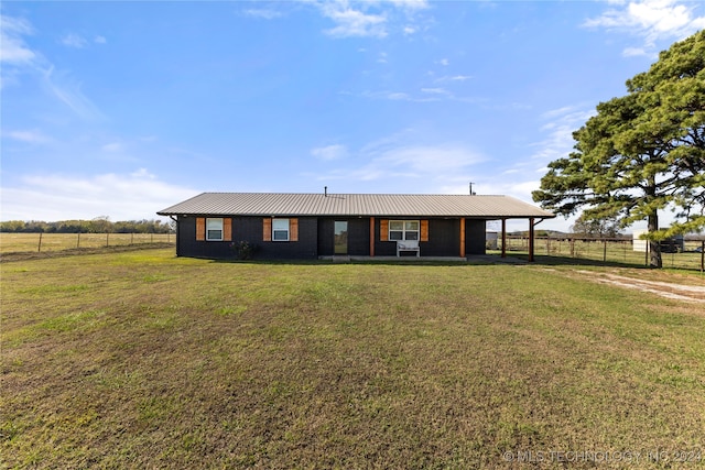 ranch-style house with a rural view and a front yard