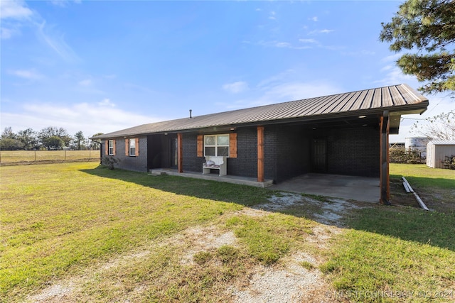 back of property with a lawn and a patio