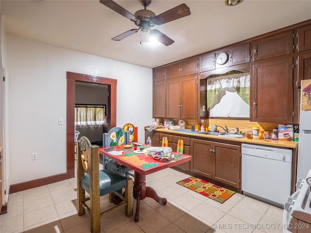 kitchen featuring ceiling fan, dishwasher, light tile patterned flooring, and sink