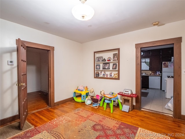 recreation room with hardwood / wood-style floors